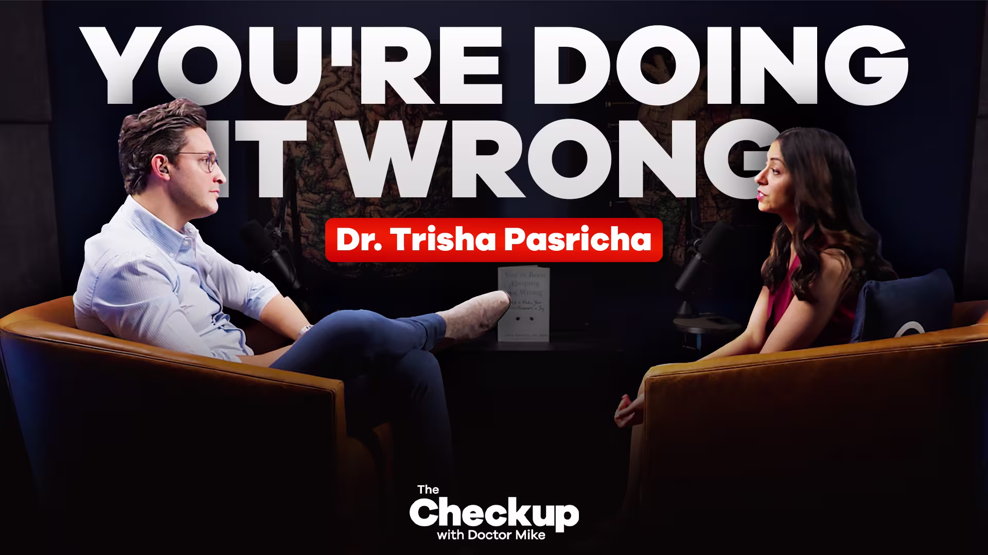 Two people in studio with 'You're Doing It Wrong'