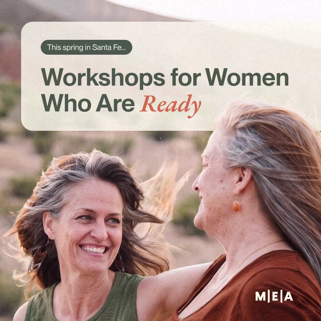 Two women smiling in a desert landscape